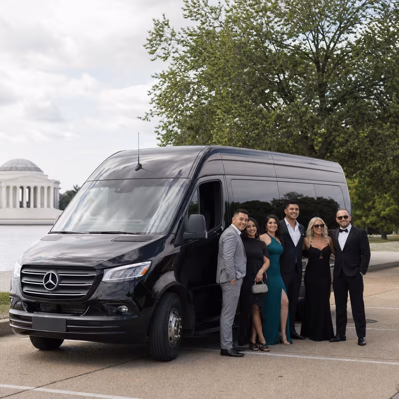 Group beside a Mercedes Sprinter limo from the Washington fleet