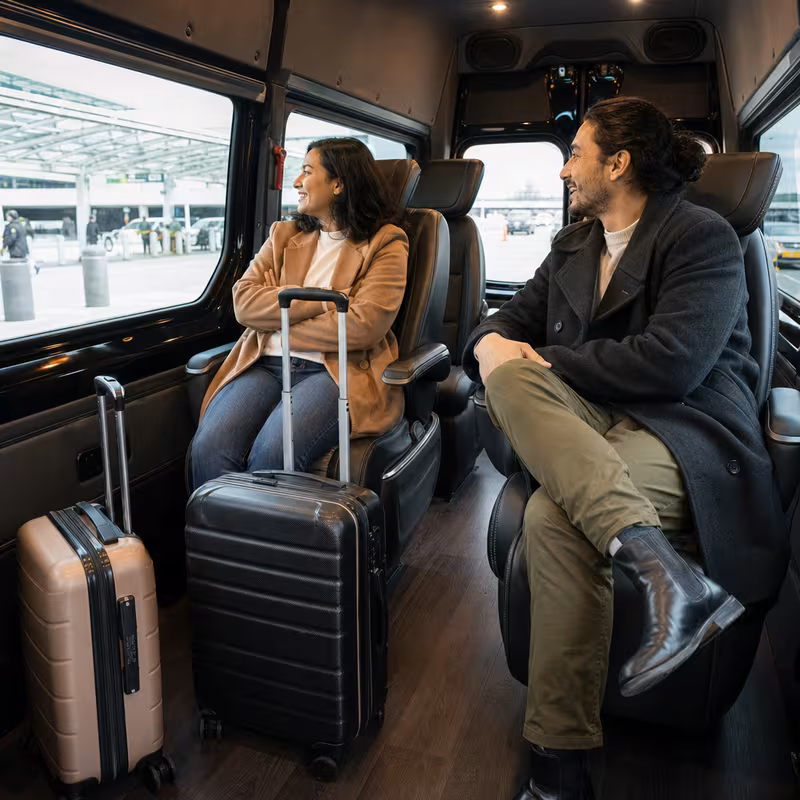 Passengers loading luggage while boarding an Washington group shuttle