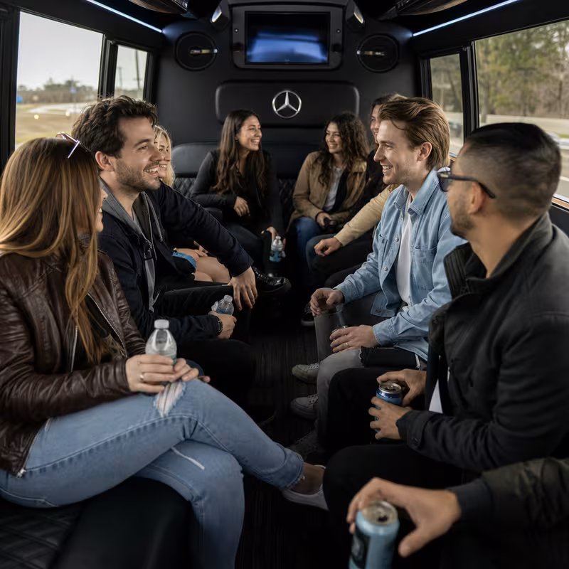 Group boarding a white charter bus for Concert Transportation transportation in Washington