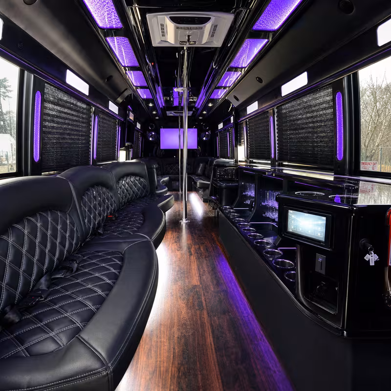 Party bus interior with wraparound leather seating and LED lighting in Washington