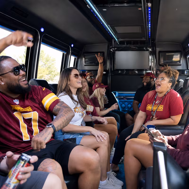 Group boarding a white charter bus for Sporting Event Transportation transportation in Washington