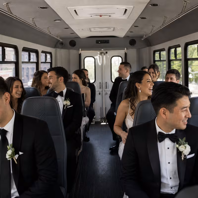 Group boarding a white charter bus for Wedding Transportation transportation in Washington