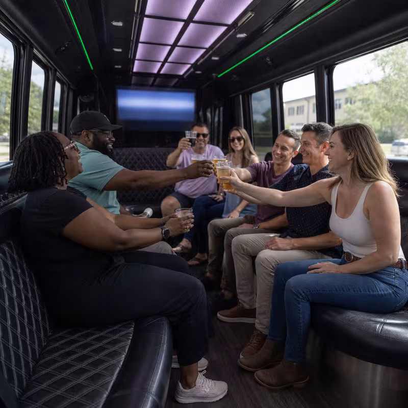 Group boarding a white charter bus for Winery & Brewery Tour Transportation transportation in Washington